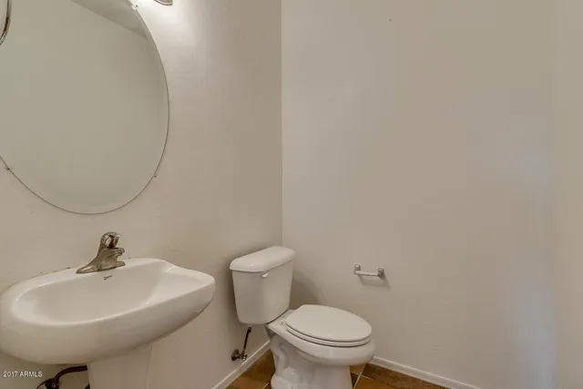 a bathroom with a sink a toilet and mirror