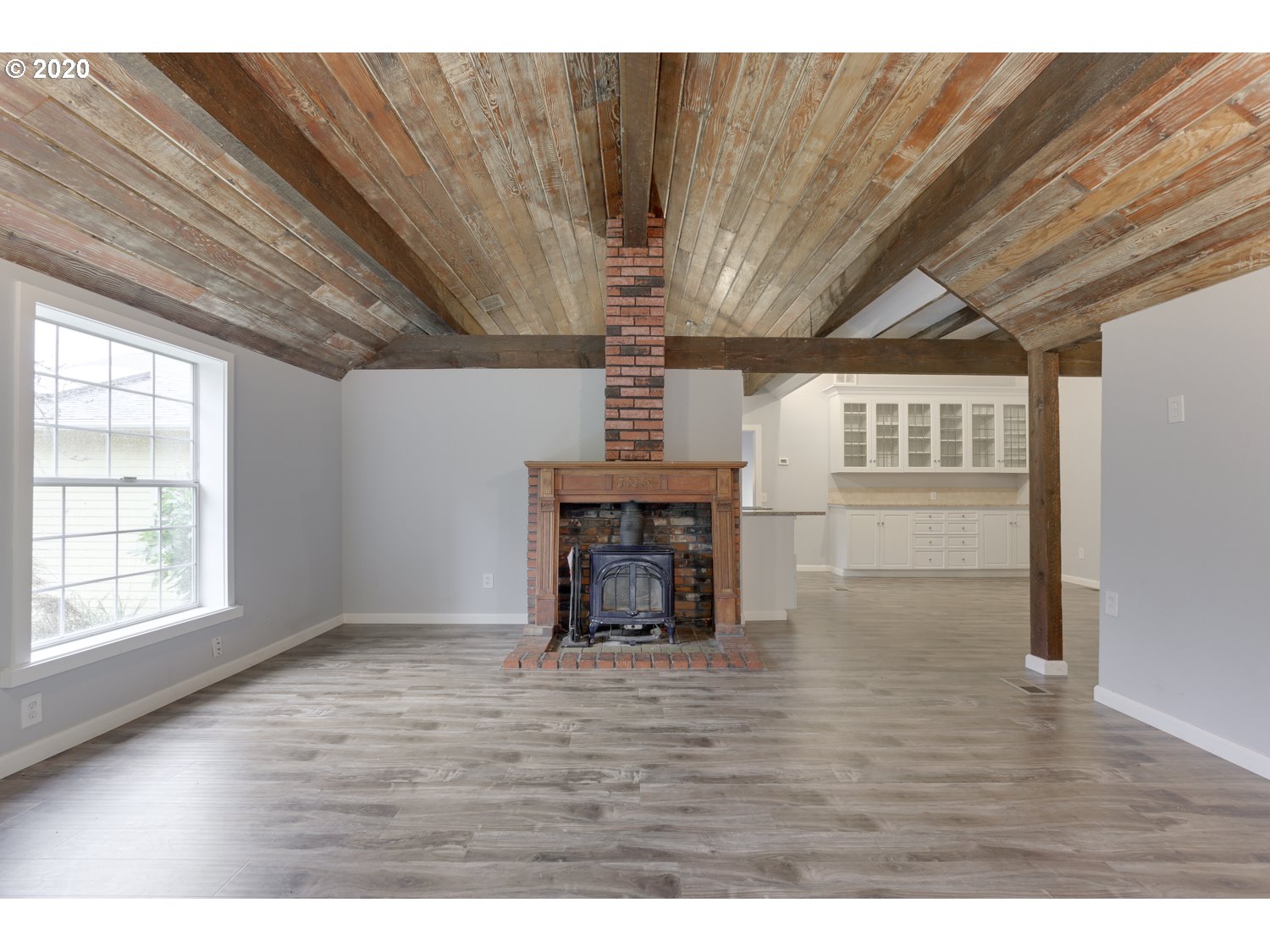 20379 South Ferguson Road Oregon City, OR 97045 - Photo 12 of 32 a view of an empty room with wooden floor fireplace and a window