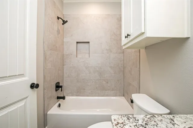 a bathroom with a bathtub and shower