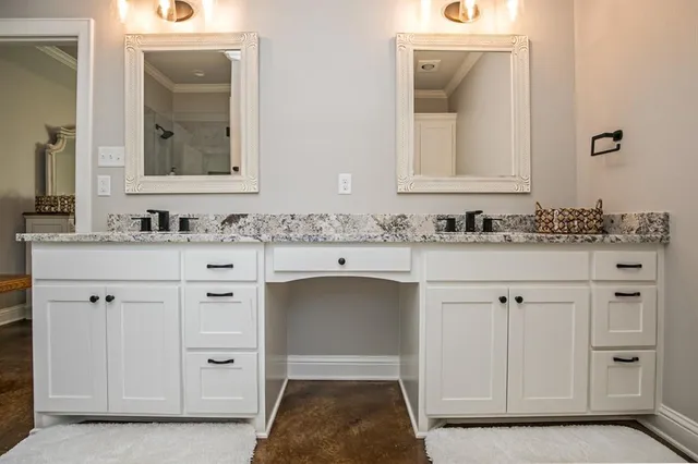 a bathroom with a sink vanity and mirror