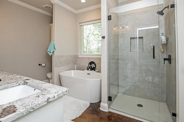 a bathroom with a bathtub sink vanity and granite
