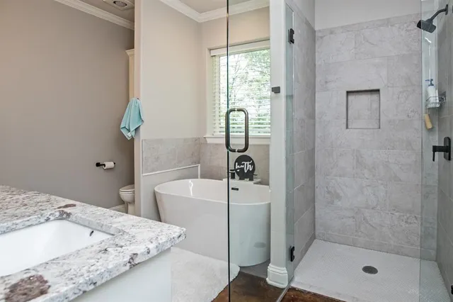 a bathroom with a tub and shower