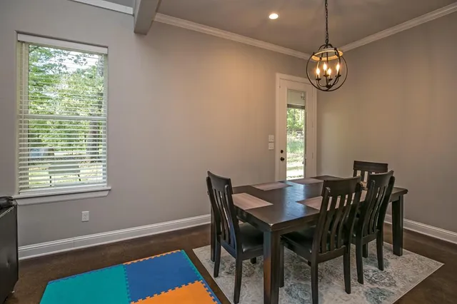 a view of a dining room with furniture and window
