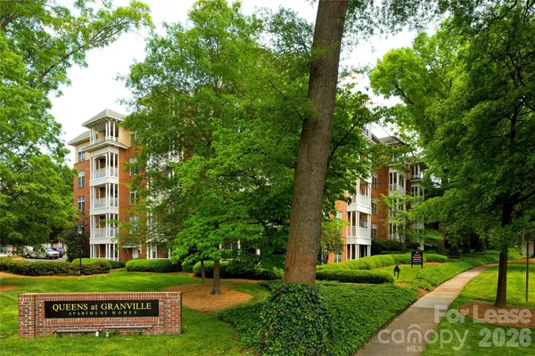 a front view of a building with a garden