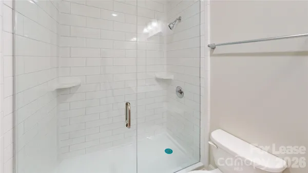 a bathroom with a shower and toilet