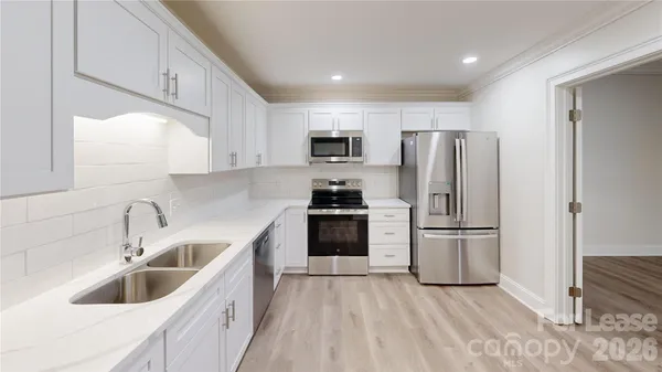 a kitchen with a refrigerator sink and microwave