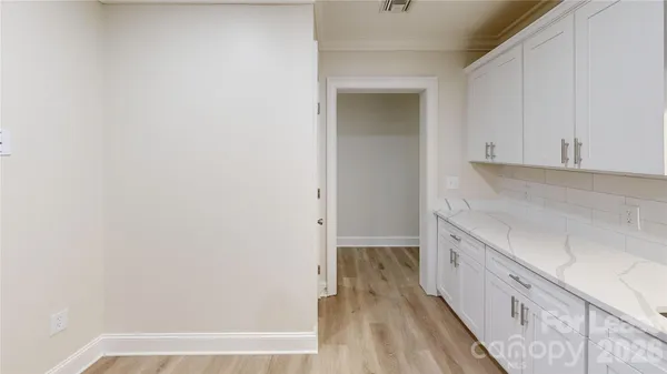 a view of hallway with wooden floor