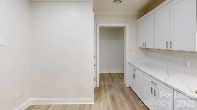 a view of hallway with wooden floor