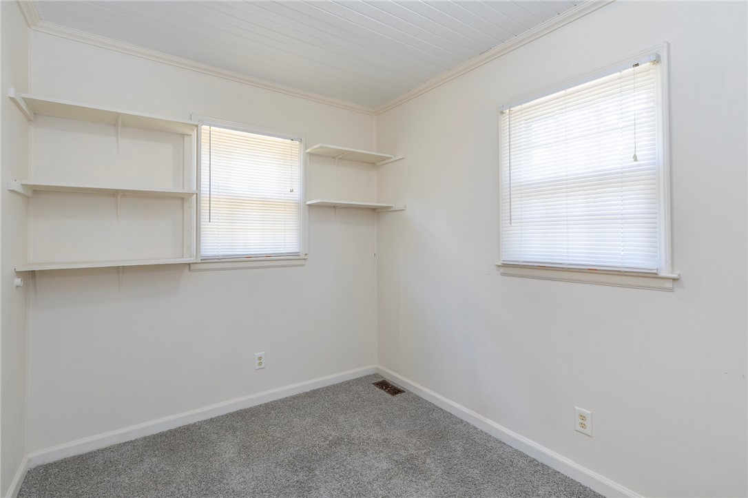 201 Blue Ridge Circle Belton, SC 29627 - Photo 8 of 30 Plentiful built-in shelving and classic wood panel ceilings highlight this cozy, carpeted bedroom.