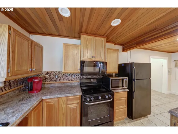 a kitchen with granite countertop sink and cabinets