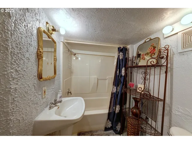 a spacious bedroom with a bed and a chandelier