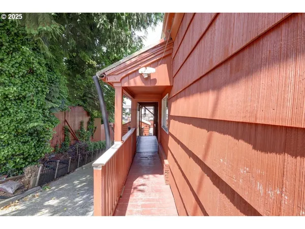 a view of a backyard with wooden fence
