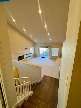 a view of a hallway with wooden floor and entryway