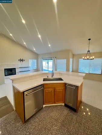a kitchen with stainless steel appliances granite countertop a sink and a stove top oven