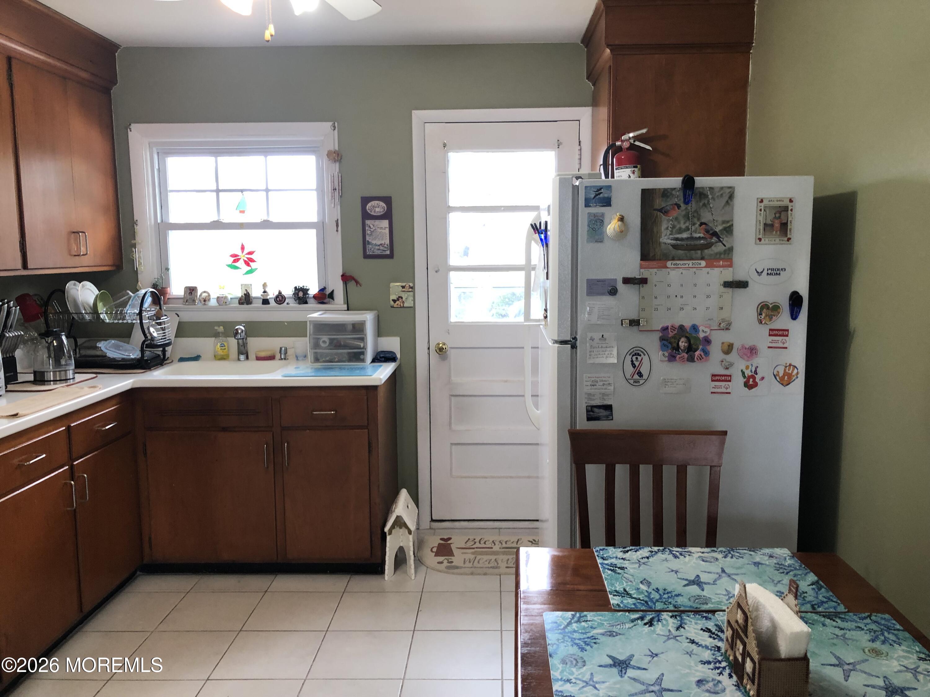 1122 Pine Bluff Avenue Point Pleasant, NJ 08742 - Photo 4 of 10 a kitchen with stainless steel appliances a sink and a refrigerator