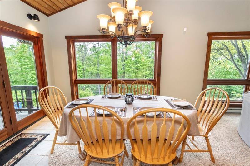 2226 County Line Road Champion, PA 15622 - Photo 11 of 33 a view of a dining room with furniture a chandelier and wooden floor