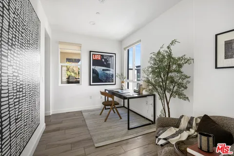 a workspace with furniture and a potted plant