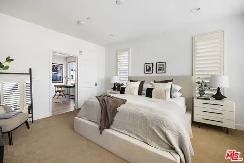 a spacious bedroom with a bed and a window
