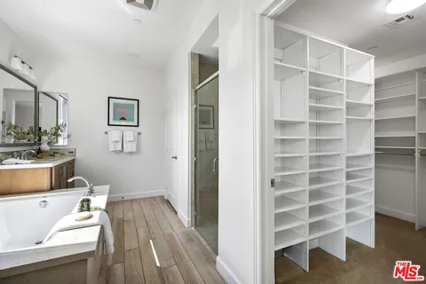 a view of a bedroom with a furniture and wooden floor