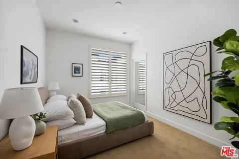 a bedroom with furniture and a window