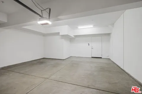 an empty room with a ceiling fan and a window