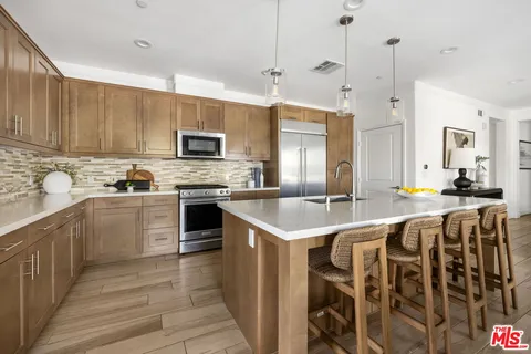 a kitchen with a sink stove and microwave