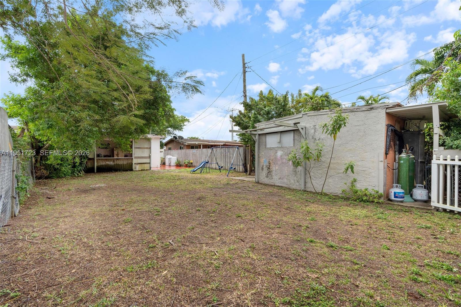 9601-9603 Southwest 36th Street Miami, FL 33165 - Photo 12 of 45 a front view of a house with a yard and garage