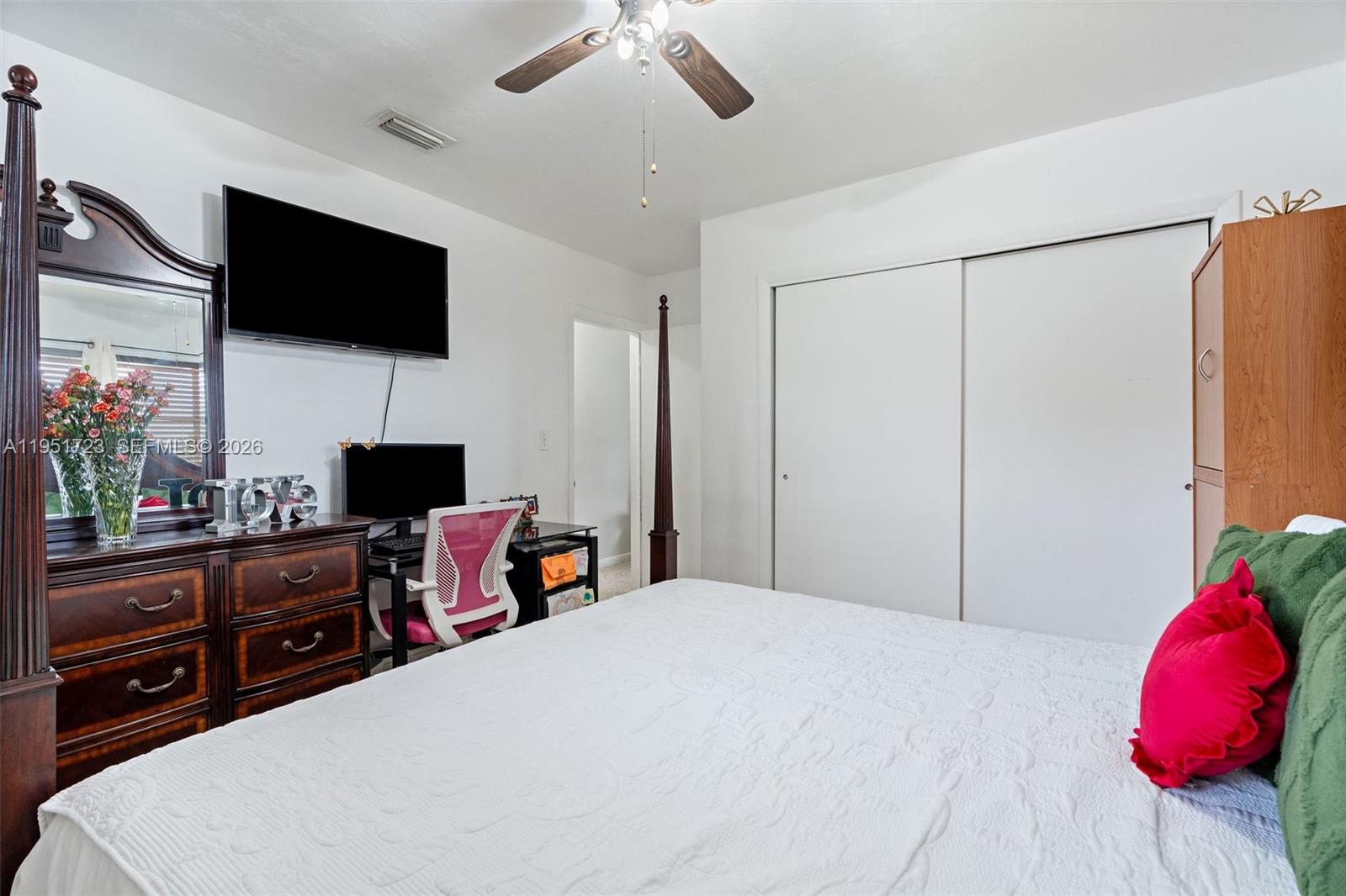 9601-9603 Southwest 36th Street Miami, FL 33165 - Photo 23 of 45 a bedroom with a bed a flat screen tv and a chandelier