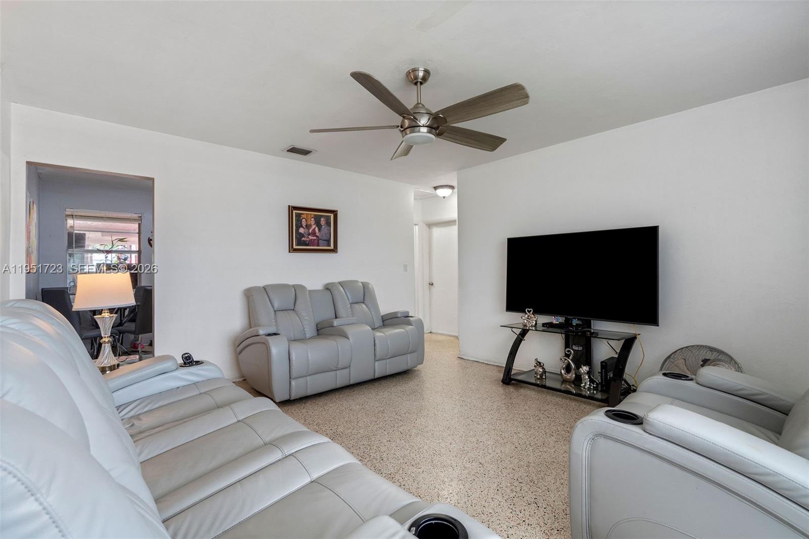 9601-9603 Southwest 36th Street Miami, FL 33165 - Photo 29 of 45 a living room with furniture and a flat screen tv