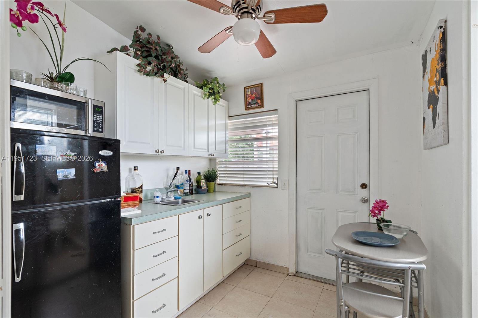 9601-9603 Southwest 36th Street Miami, FL 33165 - Photo 32 of 45 a kitchen with cabinets and window