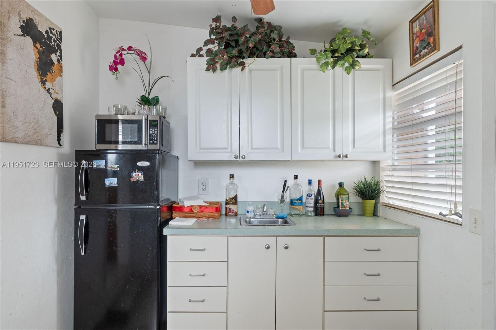 9601-9603 Southwest 36th Street Miami, FL 33165 - Photo 33 of 45 a kitchen with a refrigerator and cabinets