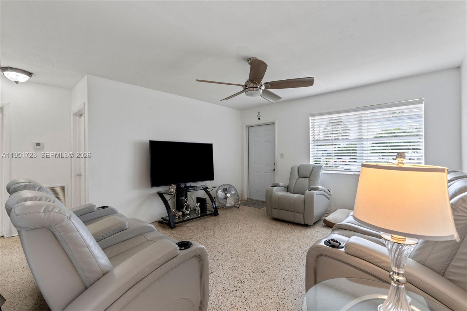 9601-9603 Southwest 36th Street Miami, FL 33165 - Photo 43 of 45 a living room with furniture and a flat screen tv