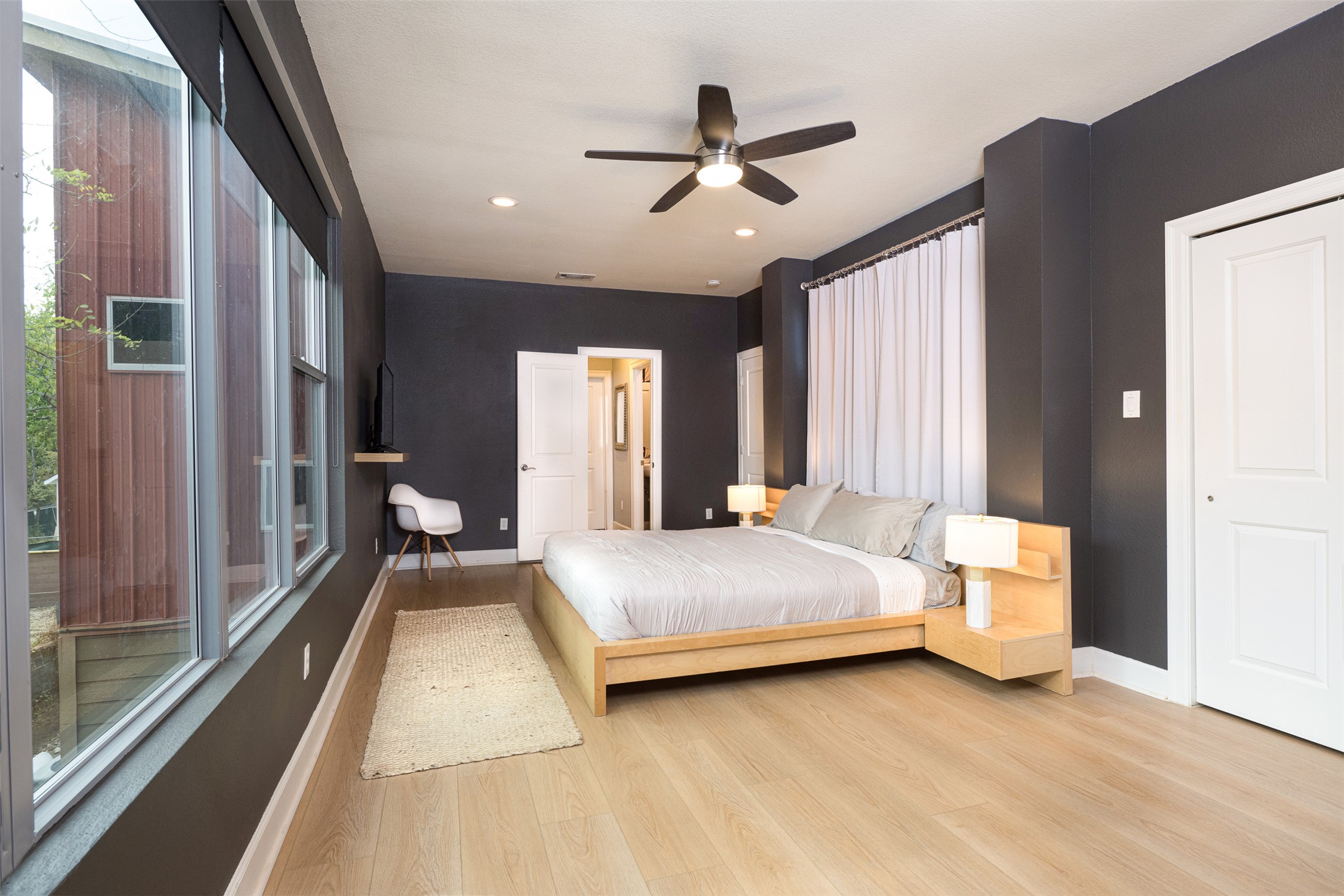 2302 East 9th Street Austin, TX 78702 - Photo 17 of 31 Hardwood floors and a sleek ceiling fan define this primary bedroom retreat.