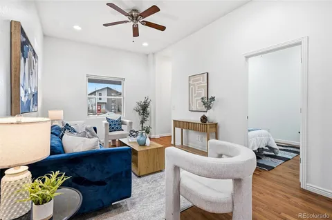 a living room with furniture and a wooden floor