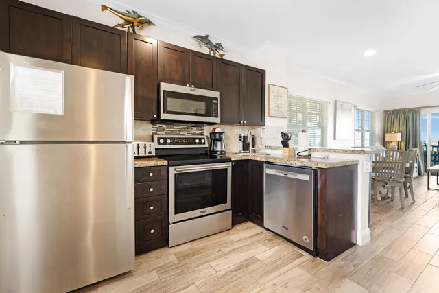 a kitchen with stainless steel appliances a refrigerator stove and microwave
