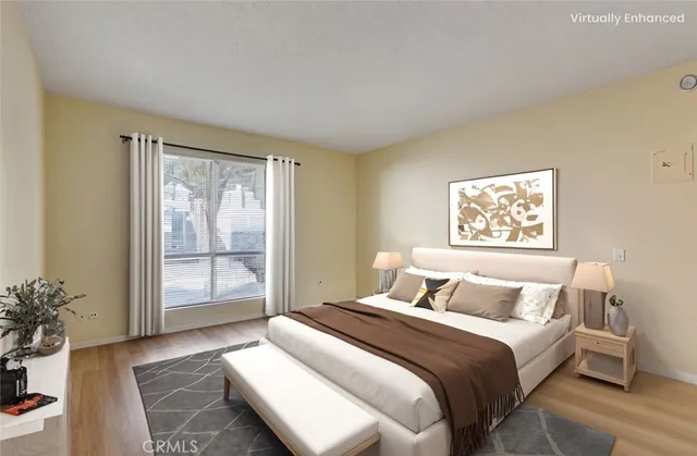 a bedroom with a large bed and a potted plant