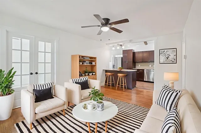 a living room with furniture and a view of kitchen