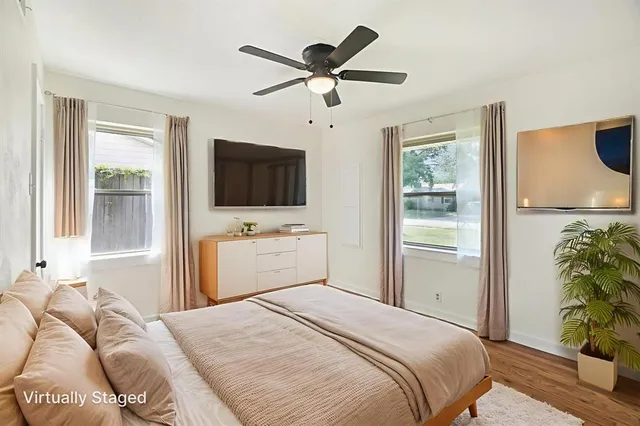 a bedroom with a bed and a flat screen tv