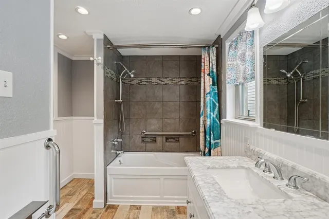 a bathroom with a tub sink and shower