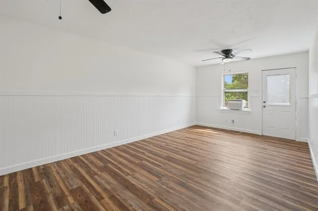 wooden floor in an empty room with a window