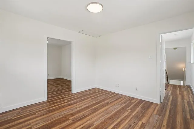 a view of a room with wooden floor and fence
