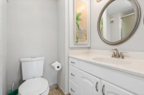 a bathroom with a toilet a sink and a mirror