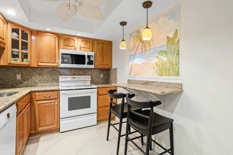 a kitchen with stainless steel appliances a stove a sink and a microwave