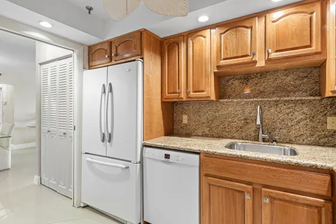 a white refrigerator freezer sitting inside of a kitchen