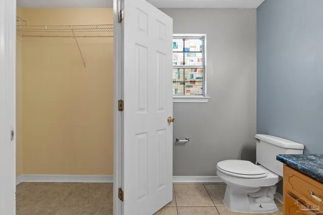 a white toilet sitting next to a bathroom sink
