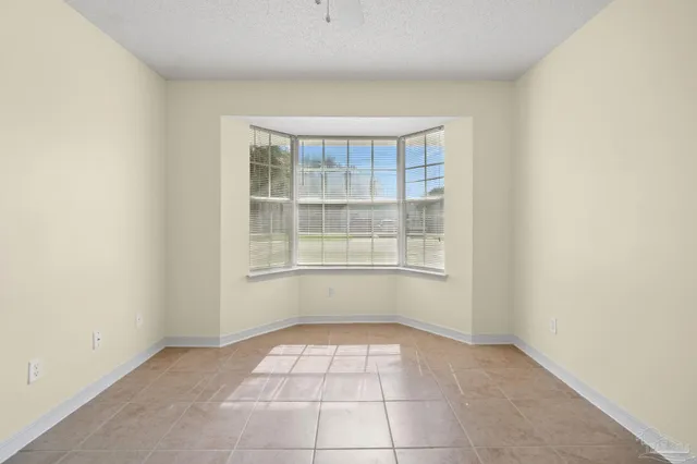 an empty room with closet and a ceiling fan
