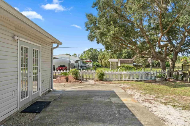 a view of a house with a backyard