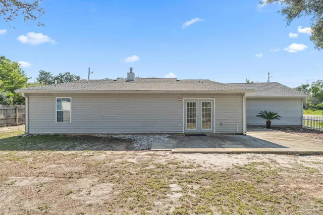 a view of a house with a backyard