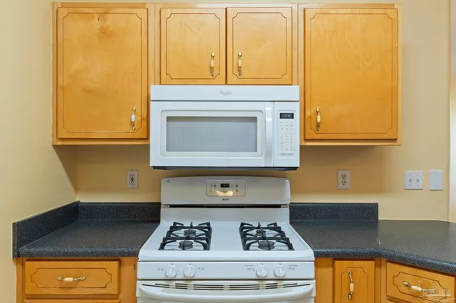 a kitchen with a stove and a microwave