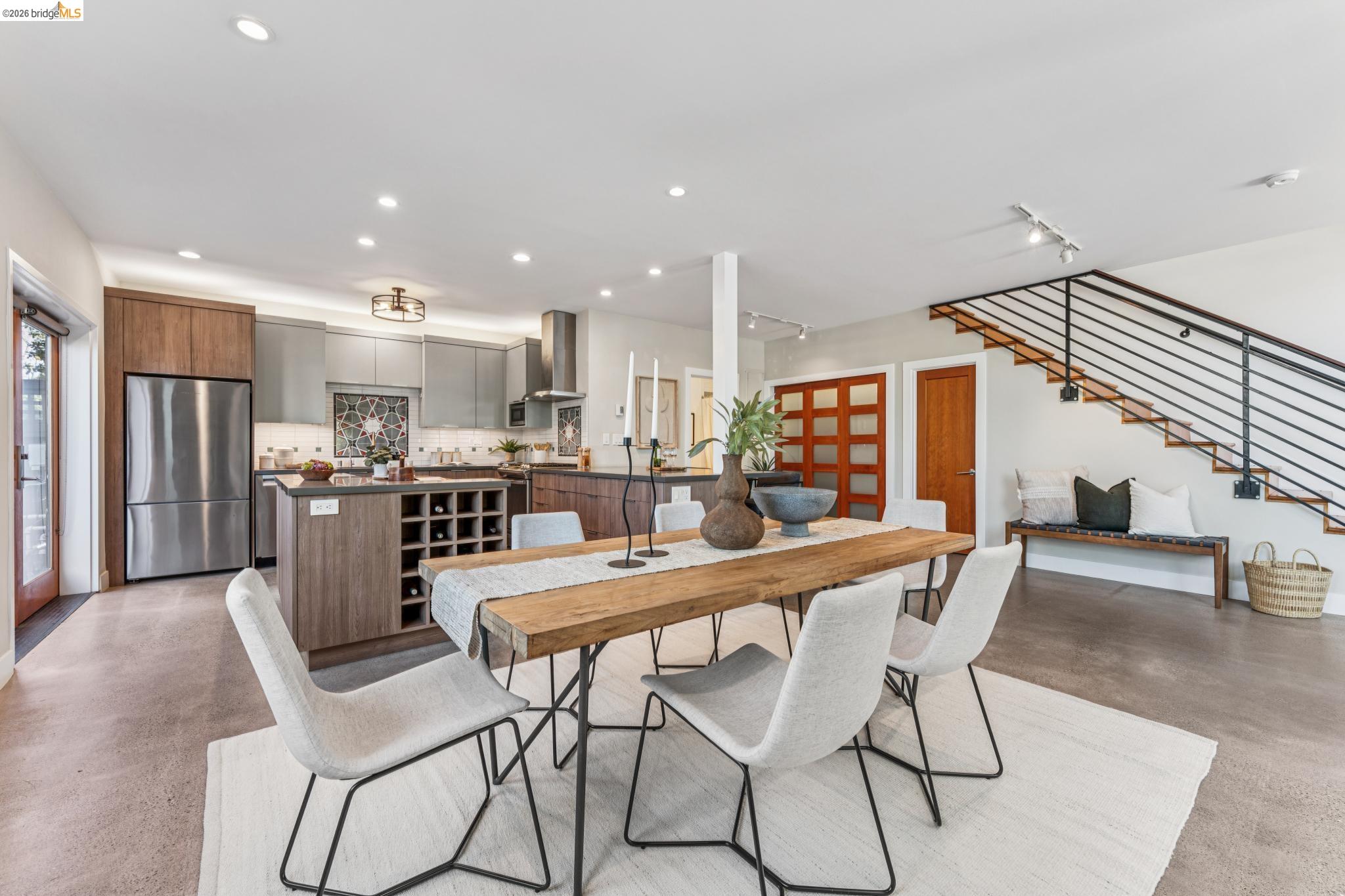 829 21st Street, Unit 1 Oakland, CA 94607 - Photo 12 of 46 a dining room with stainless steel appliances kitchen island granite countertop a dining table chairs and a refrigerator